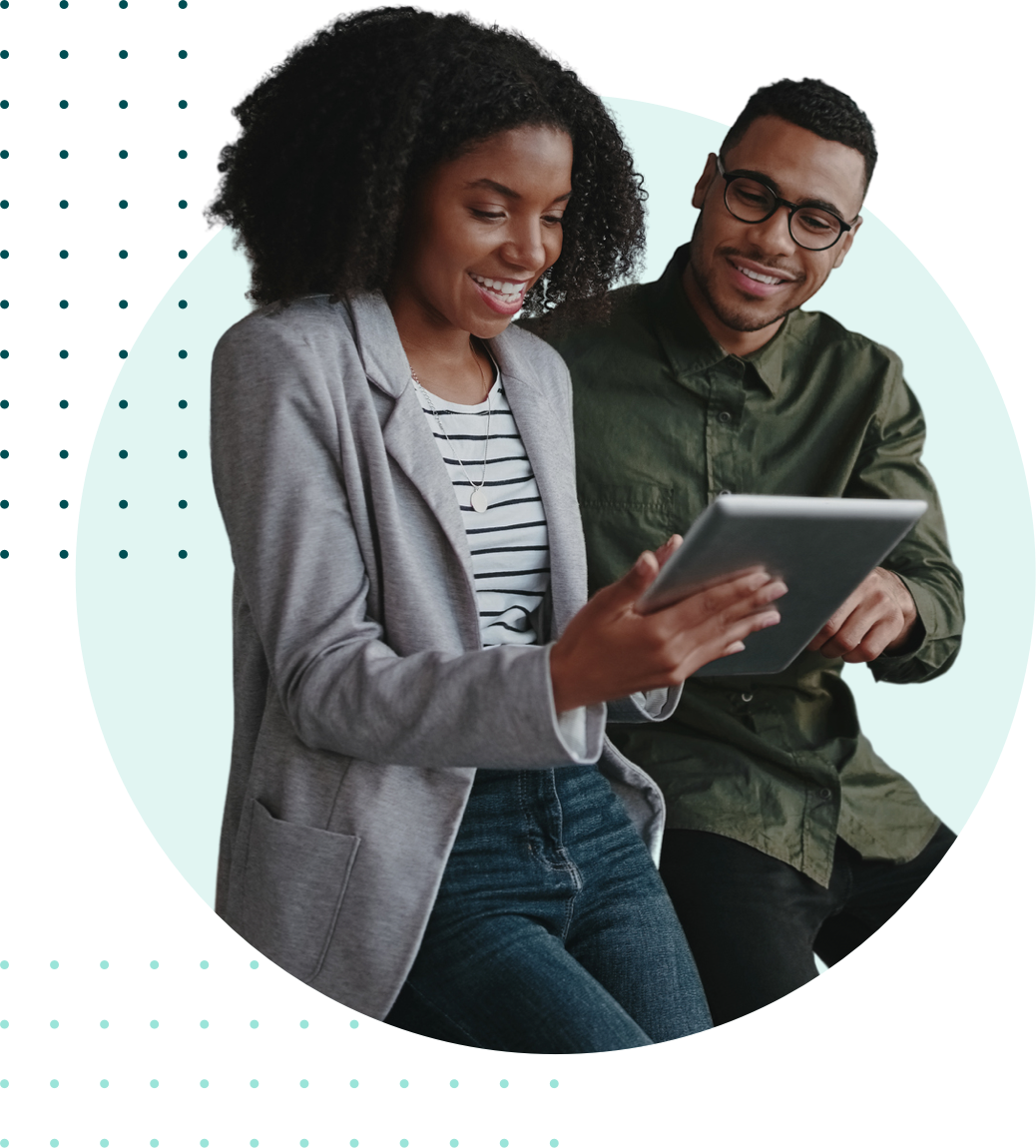 A man and a woman looking at a tablet together